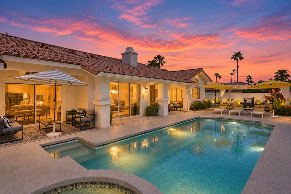 House, illuminated interiors, pool and pergola at twilight at 74797 S Cove Drive