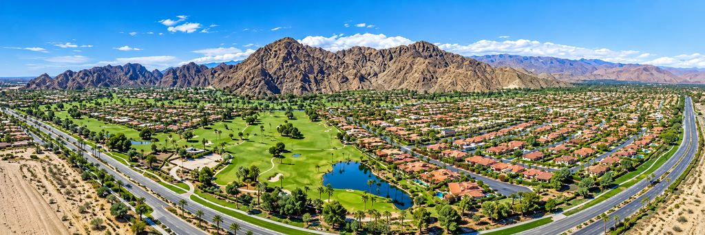 Panoramic view of homes, golf landscape and desert mountains