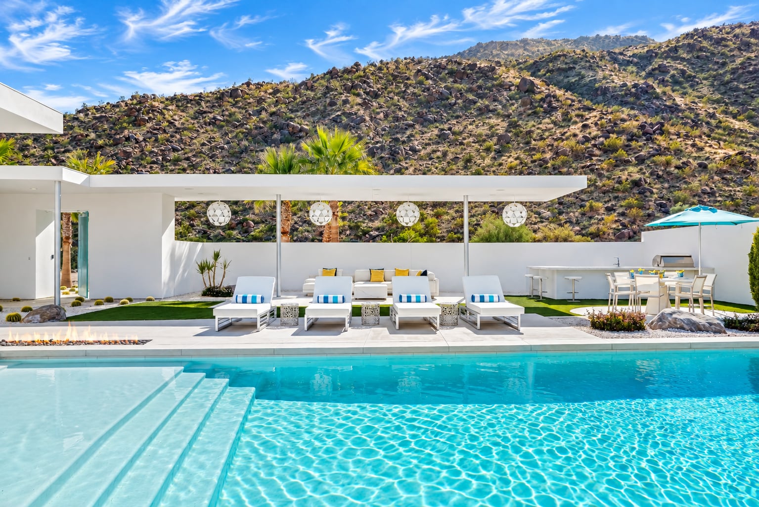 Residence and pool with desert hillside backdrop